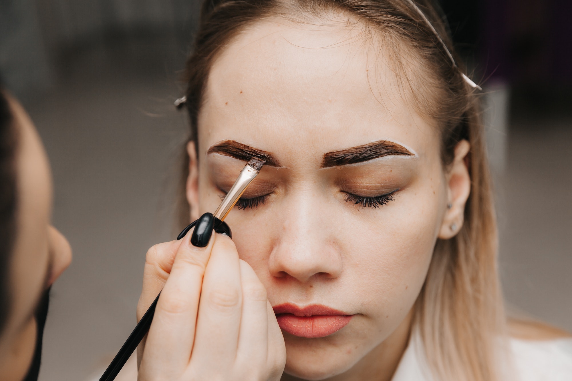girl doing eyebrow microblading. applying eyebrow paint. facial skin care. lip augmentation